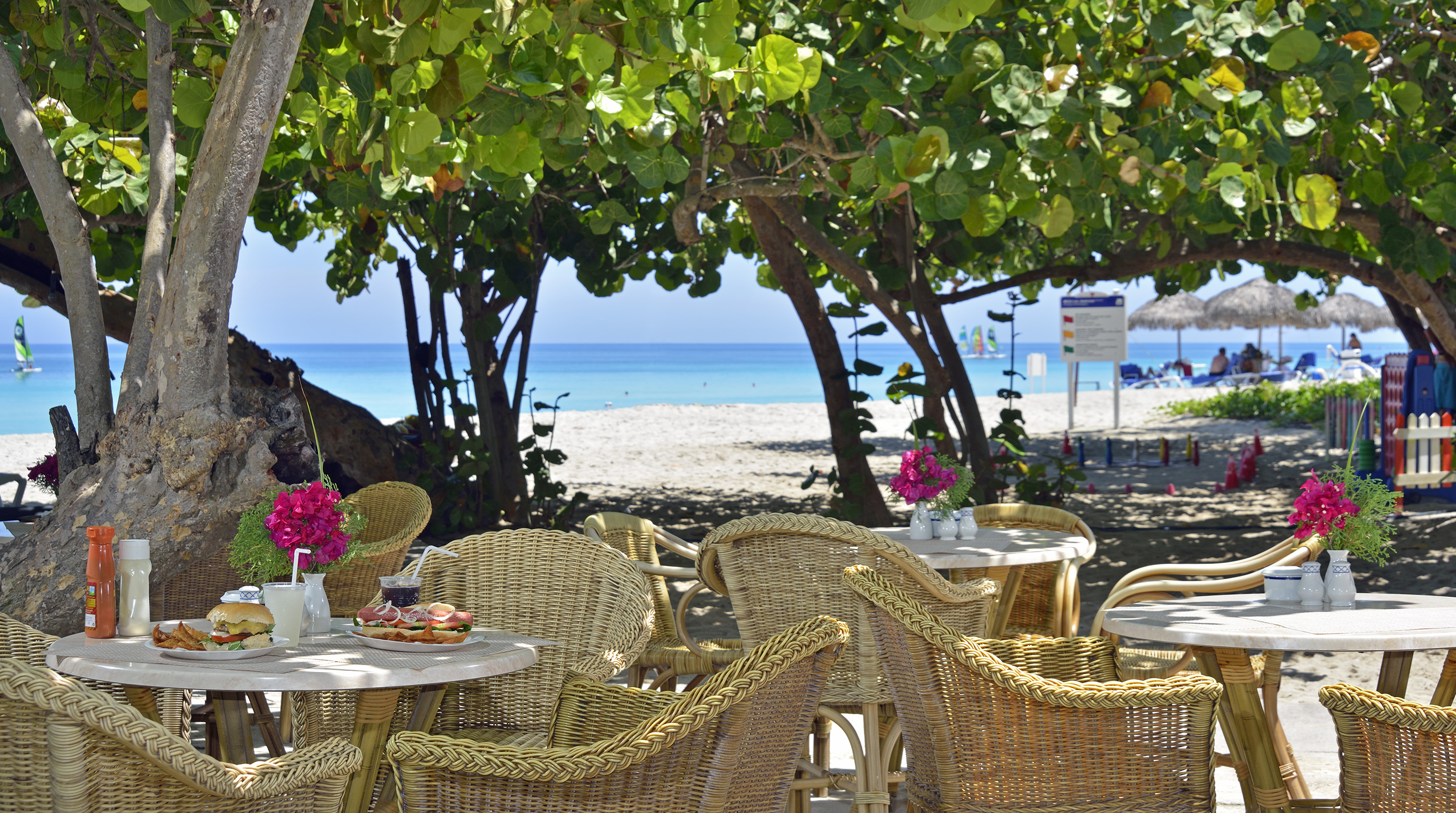 a table and chairs on a beach
