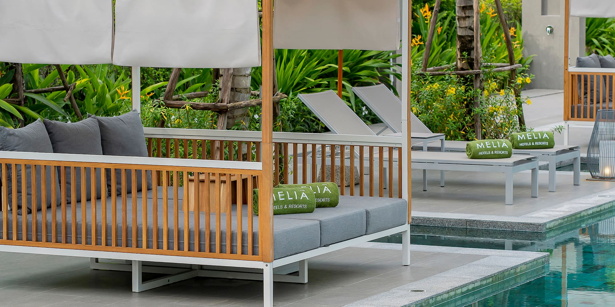 a pool with a bed and chairs