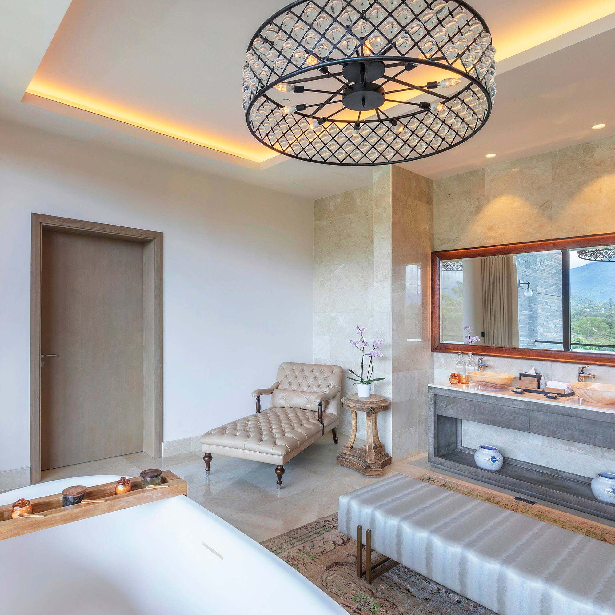 a bathroom with a large chandelier and a tub