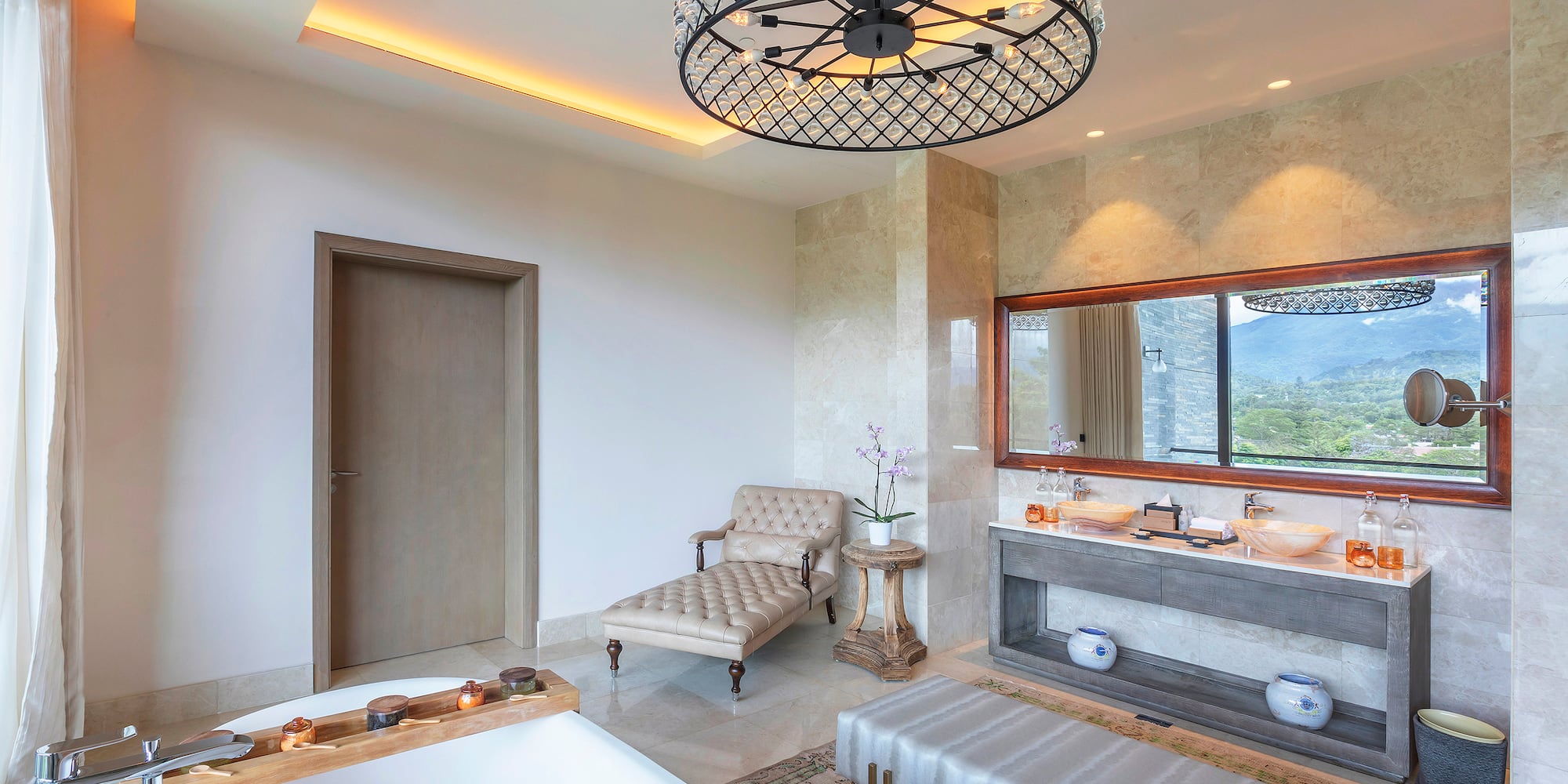 a bathroom with a large chandelier and a tub