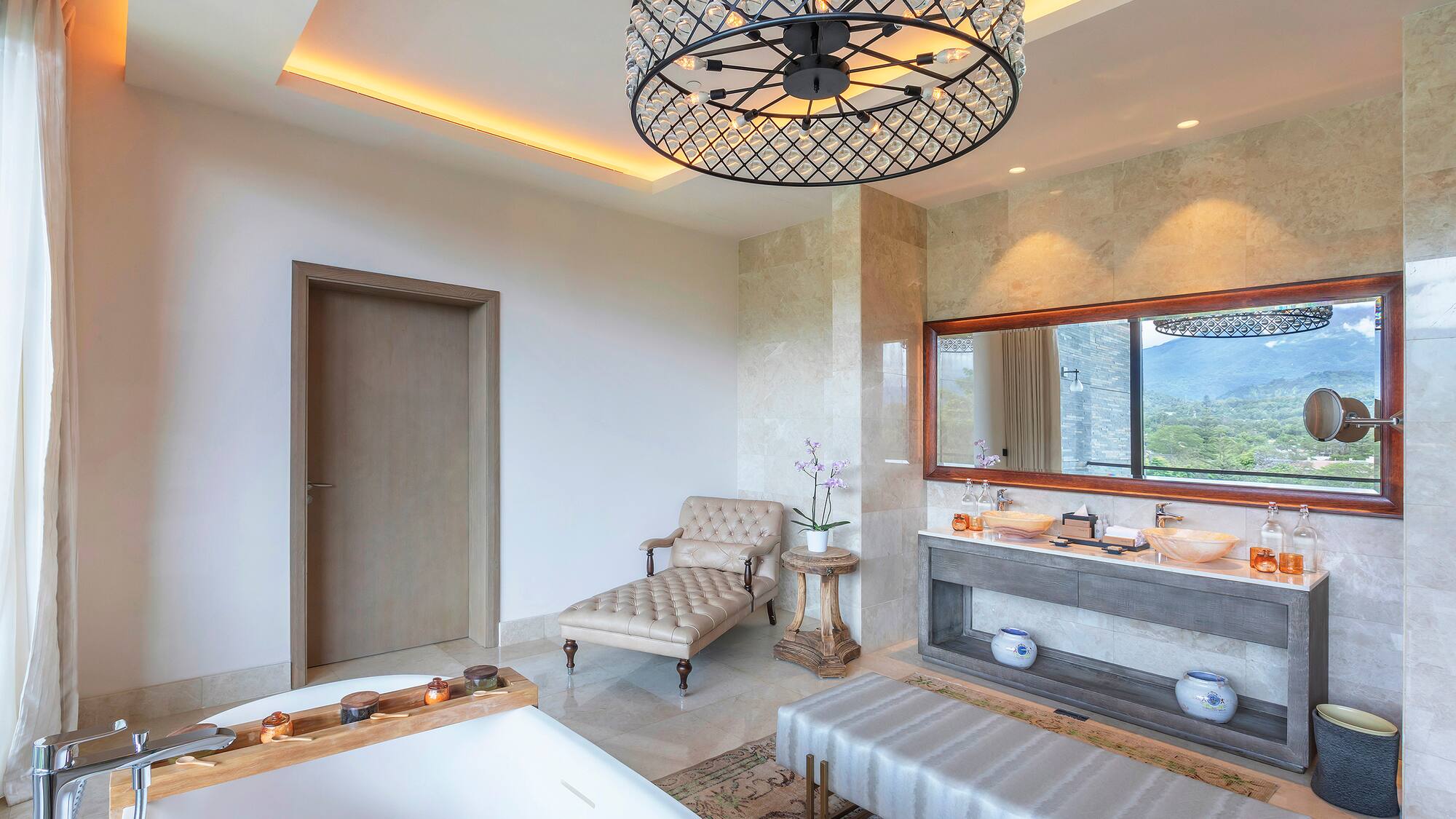 a bathroom with a large chandelier and a tub