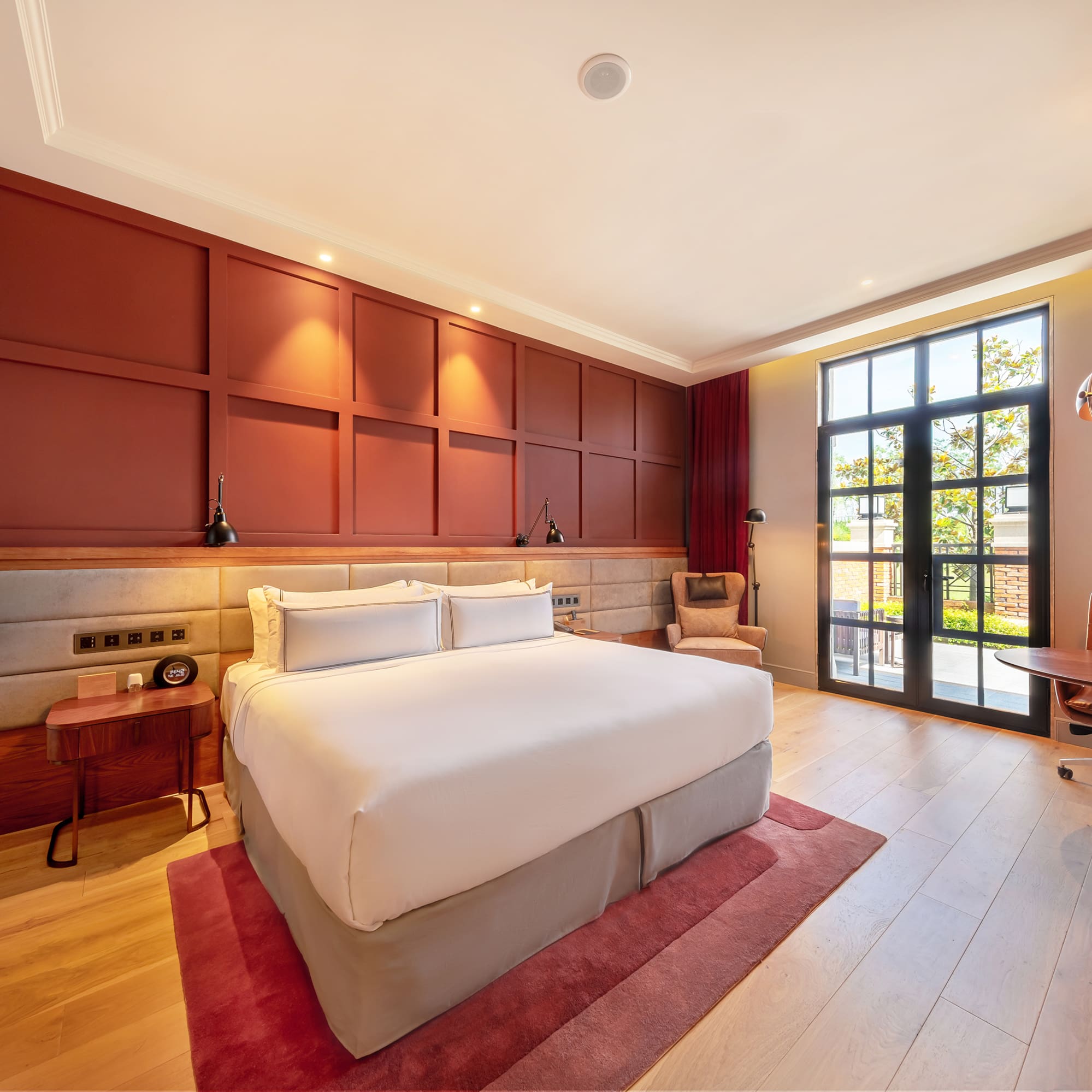 a room with a bed and a red rug