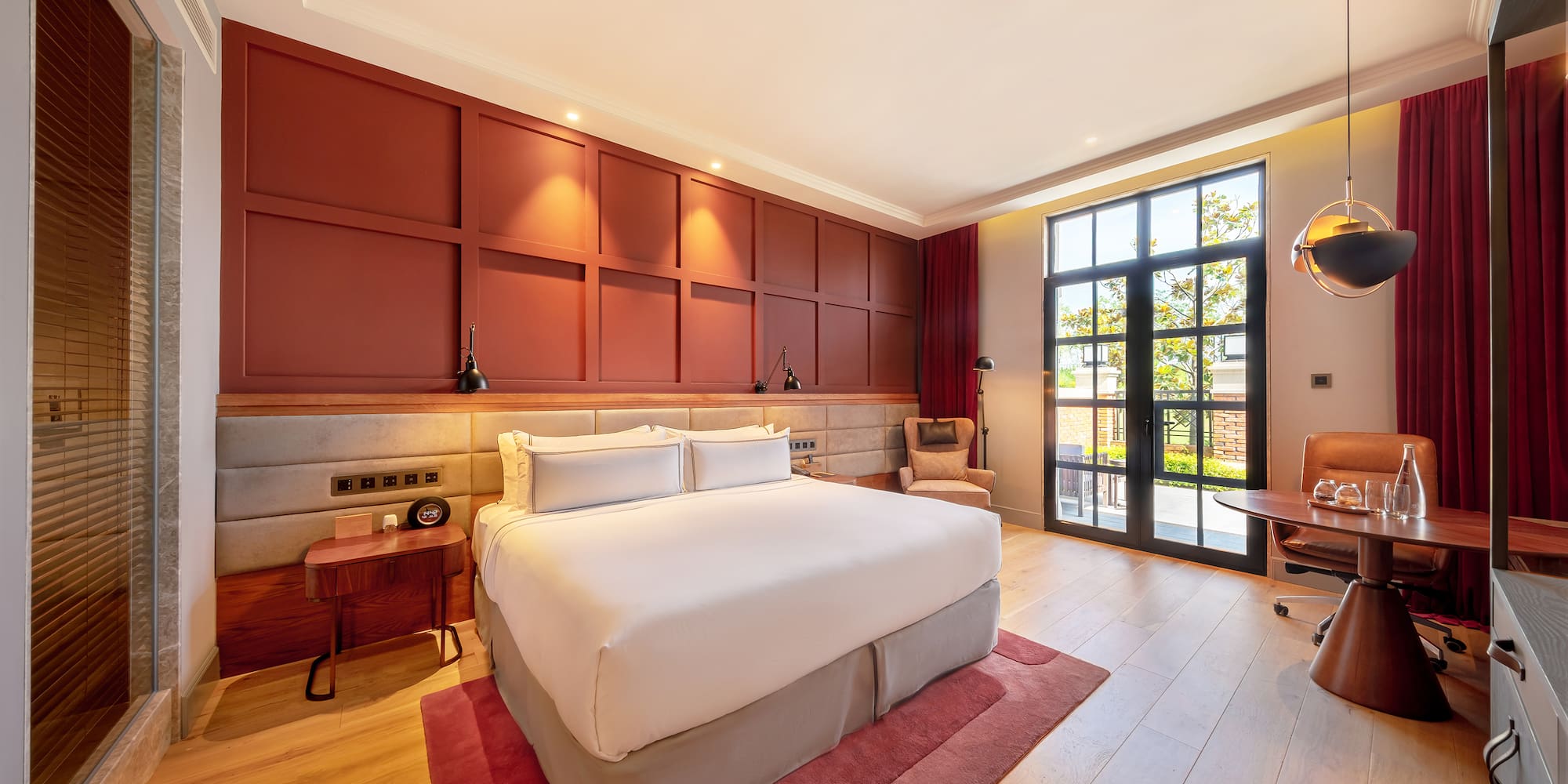 a room with a bed and a red rug