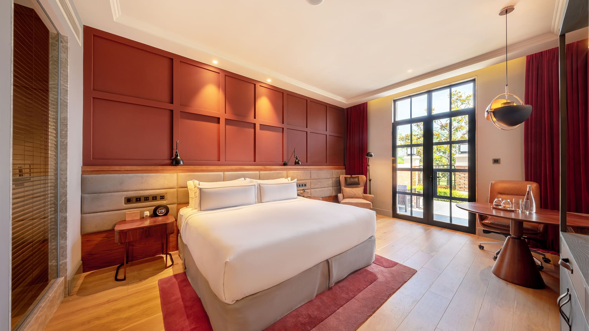 a room with a bed and a red rug