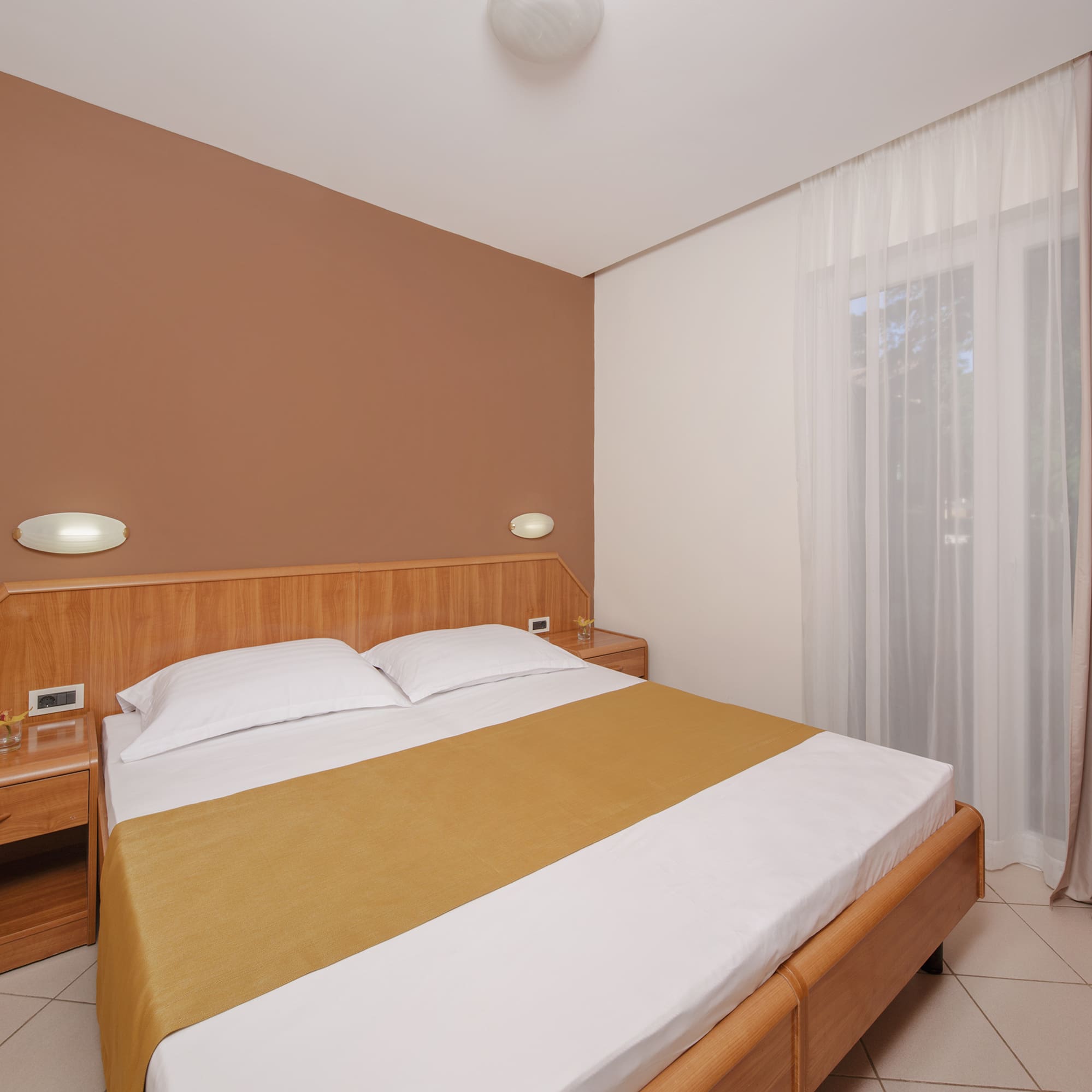 a bed with a wood headboard and a wood headboard