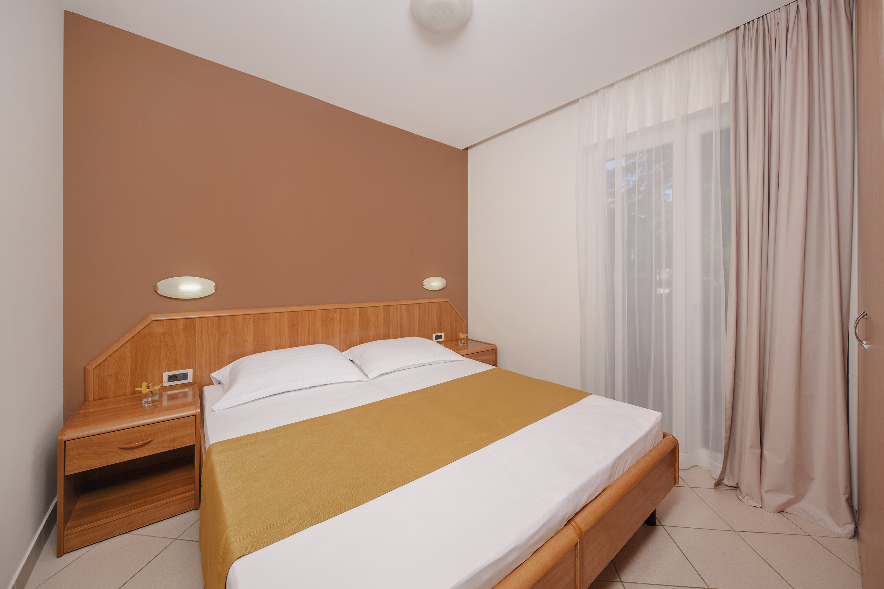 a bed with a wood headboard and a wood headboard