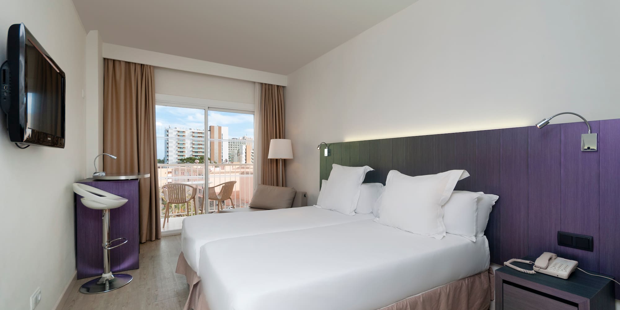 a room with two beds and a table