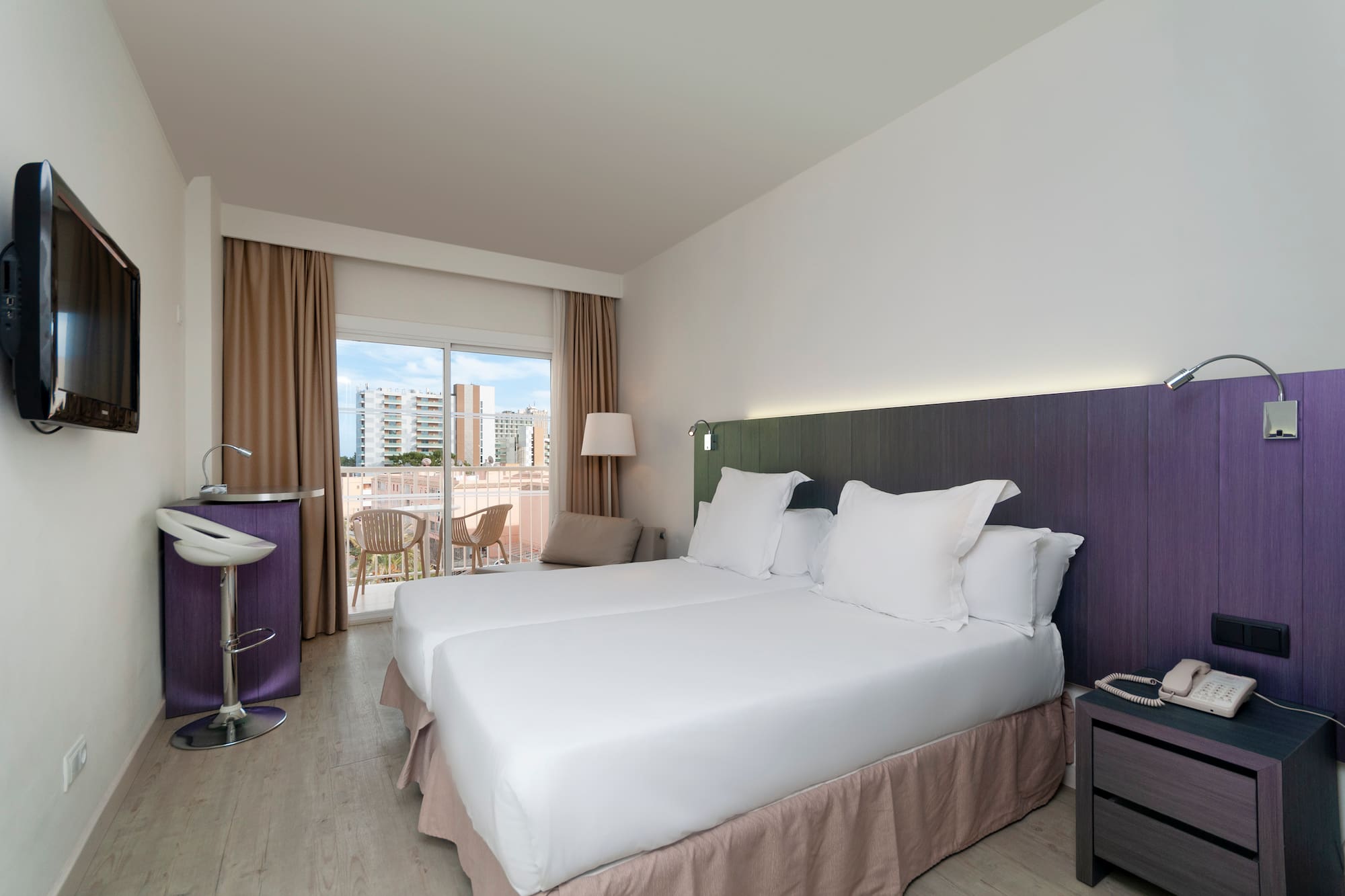 a room with two beds and a table