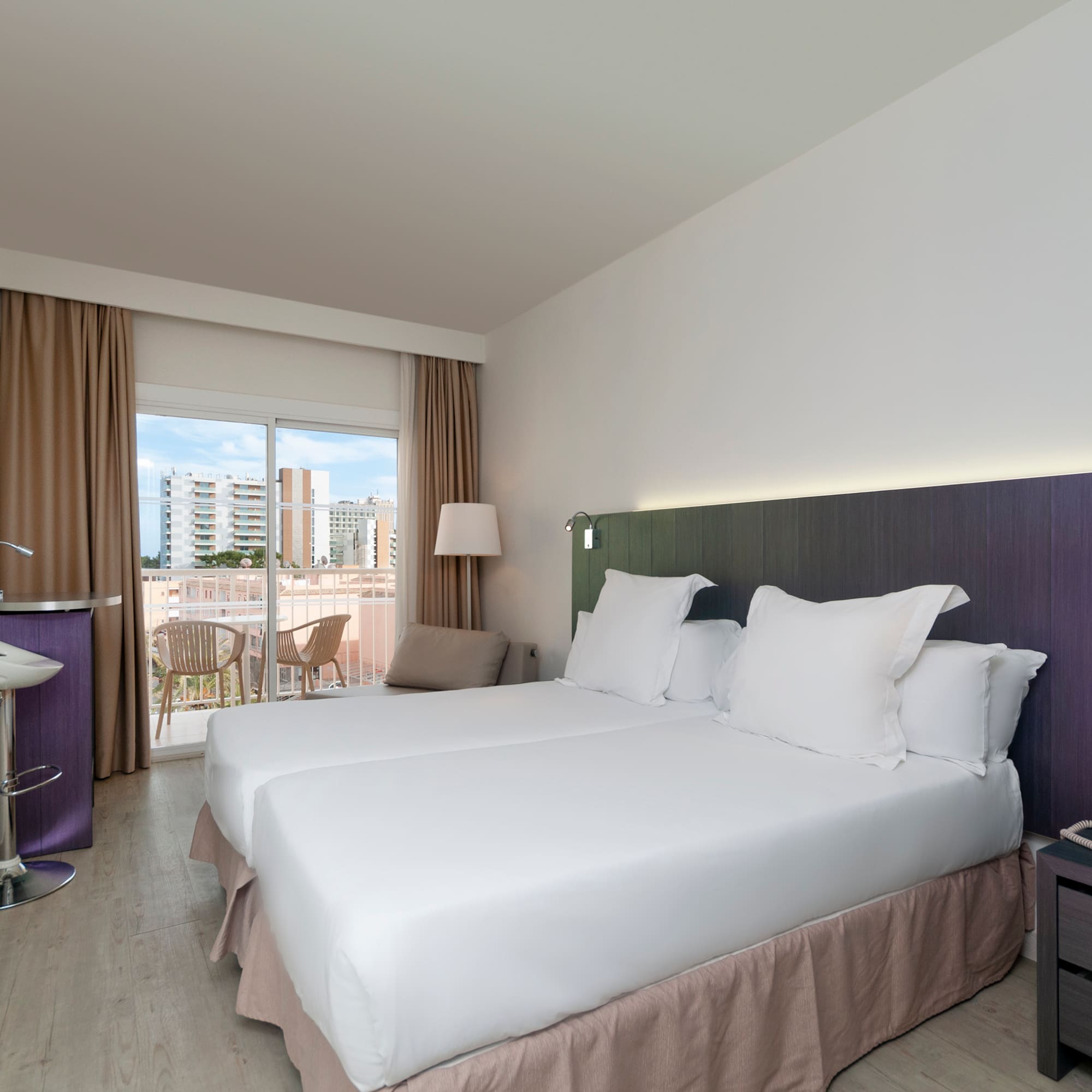 a room with two beds and a table