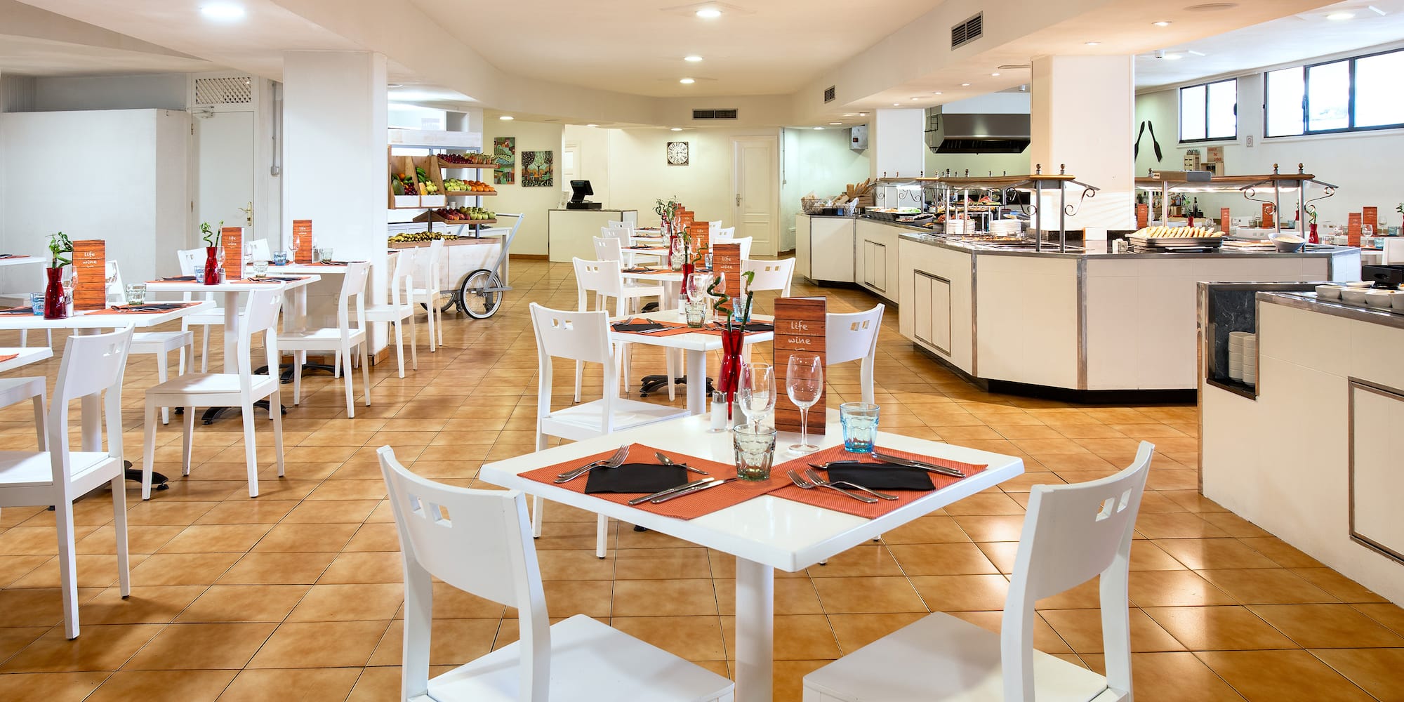 a restaurant with white tables and chairs