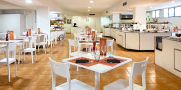 a restaurant with white tables and chairs