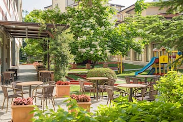 a playground with tables and chairs and a slide