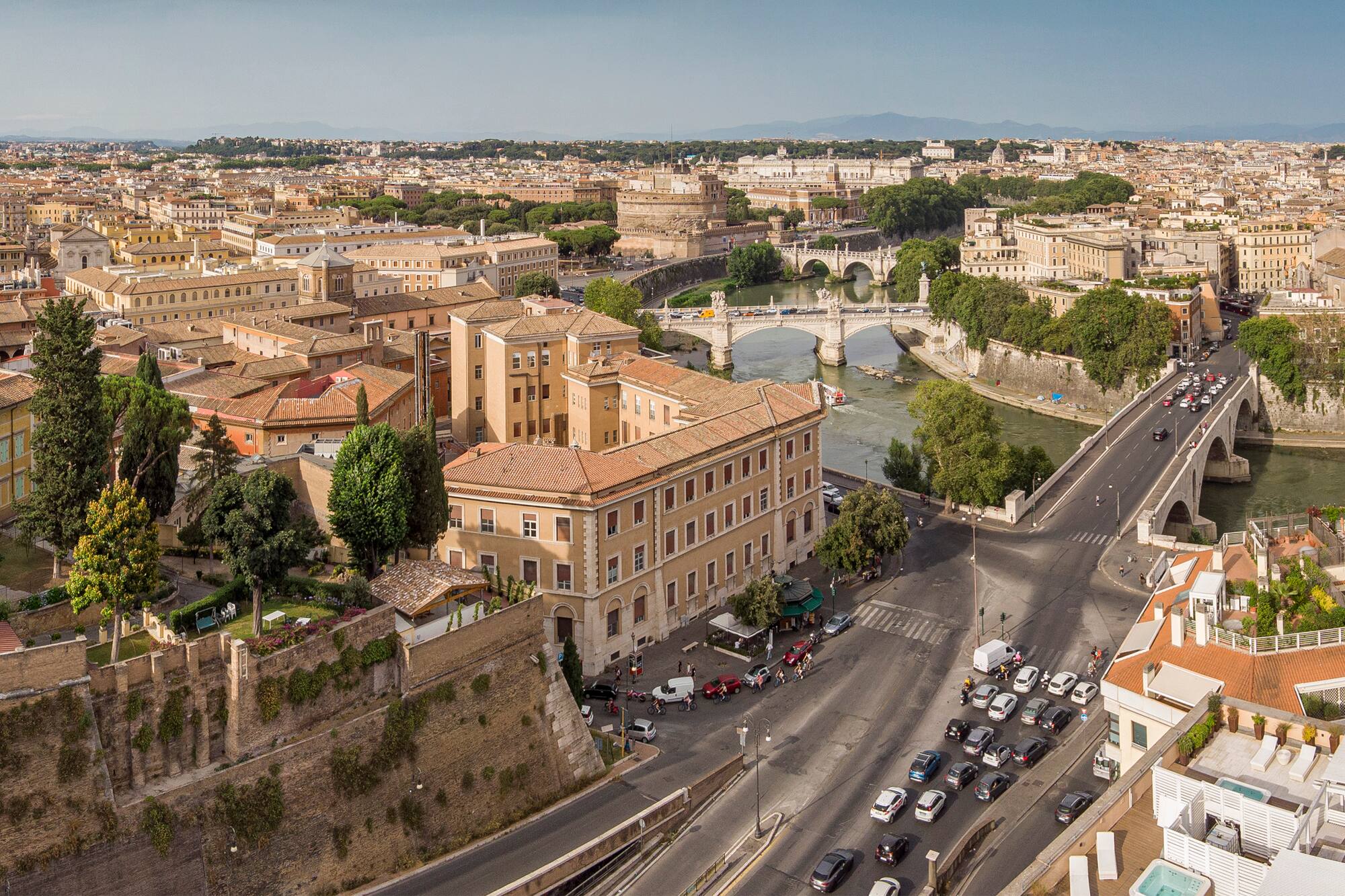 Rome aerial cityscape with Tiber River, Castel Sant'Angelo, and historic bridges.