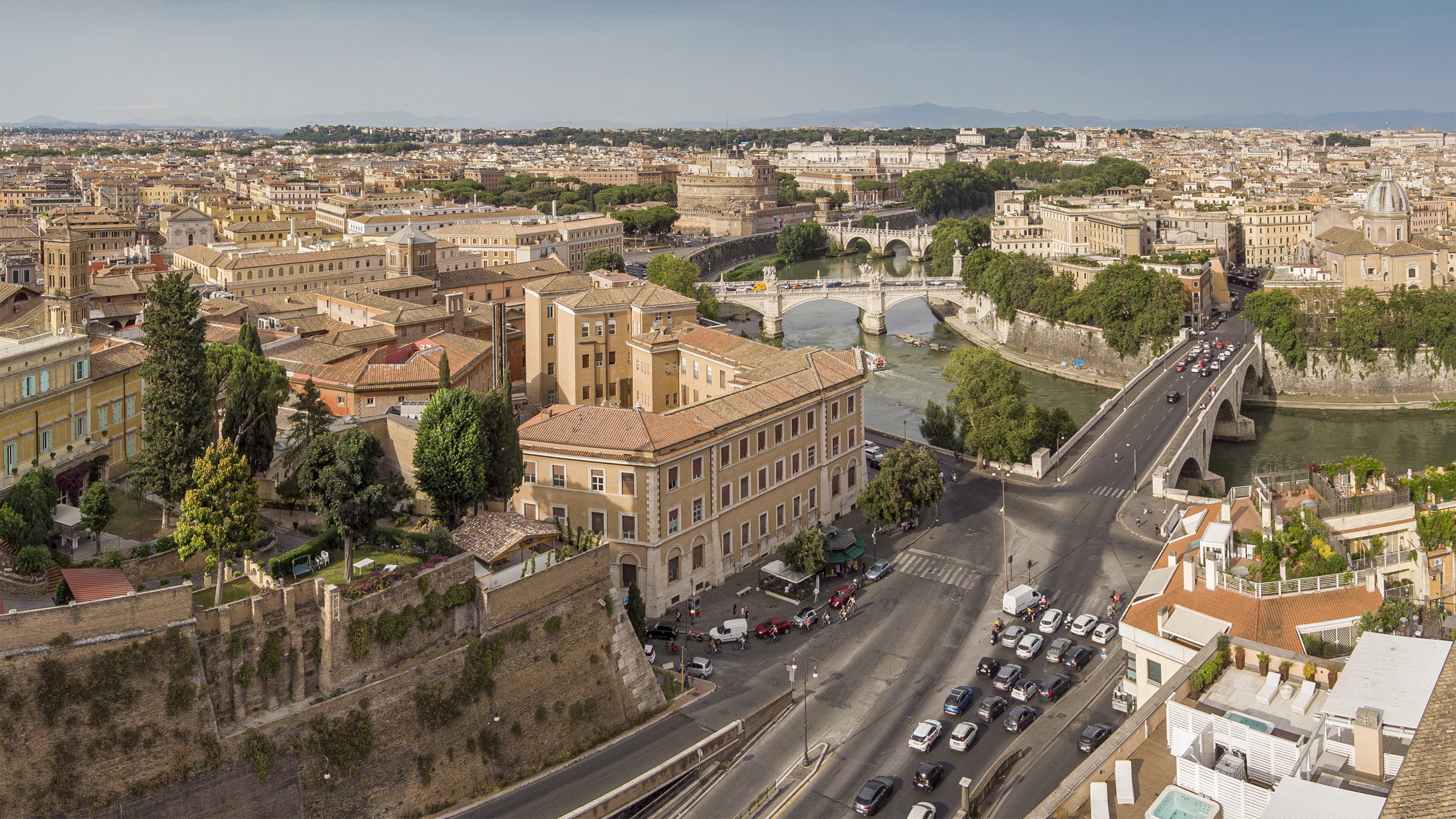 Rome aerial cityscape with Tiber River, Castel Sant'Angelo, and historic bridges.
