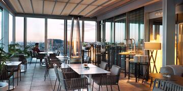 a room with tables and chairs and a fireplace