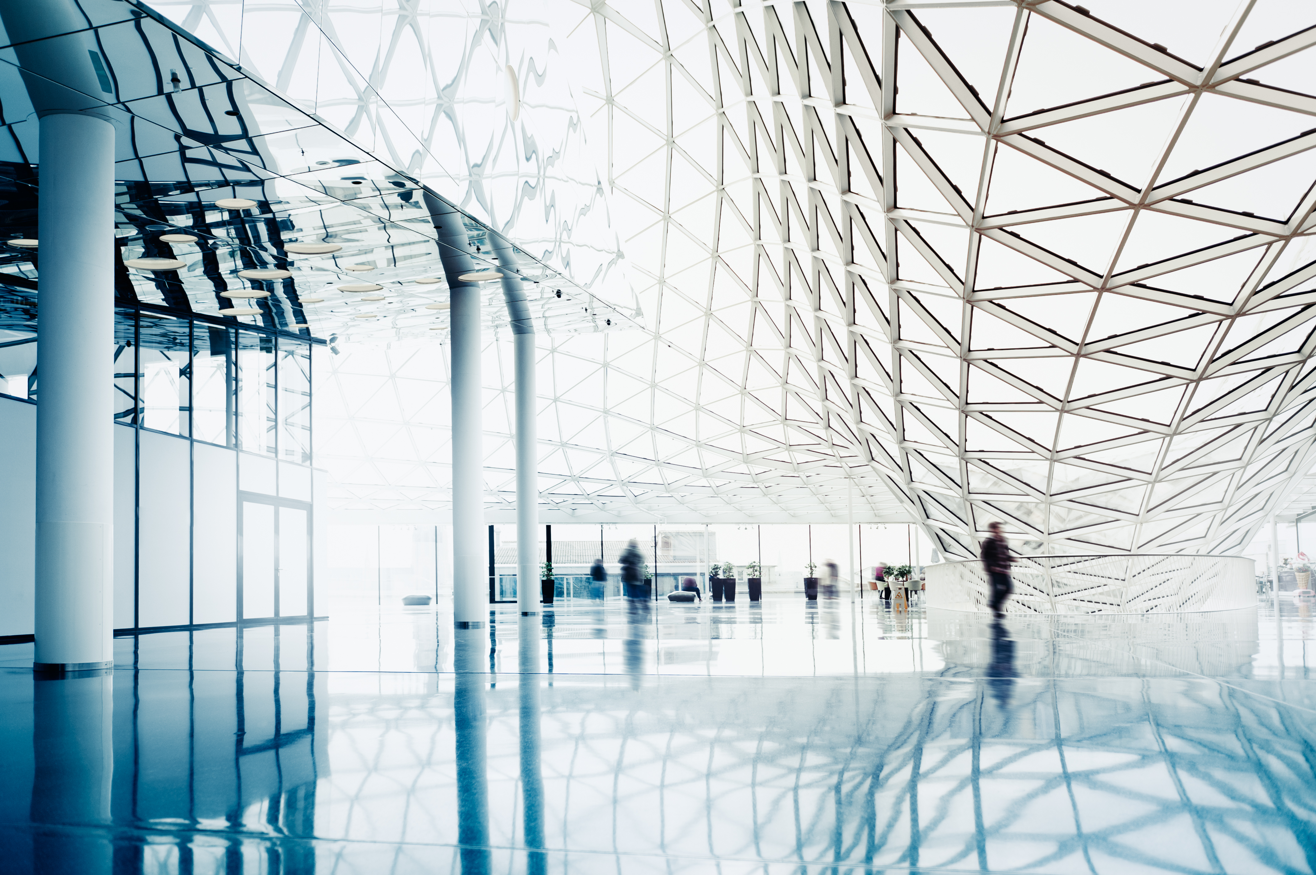 a glass ceiling with many people walking