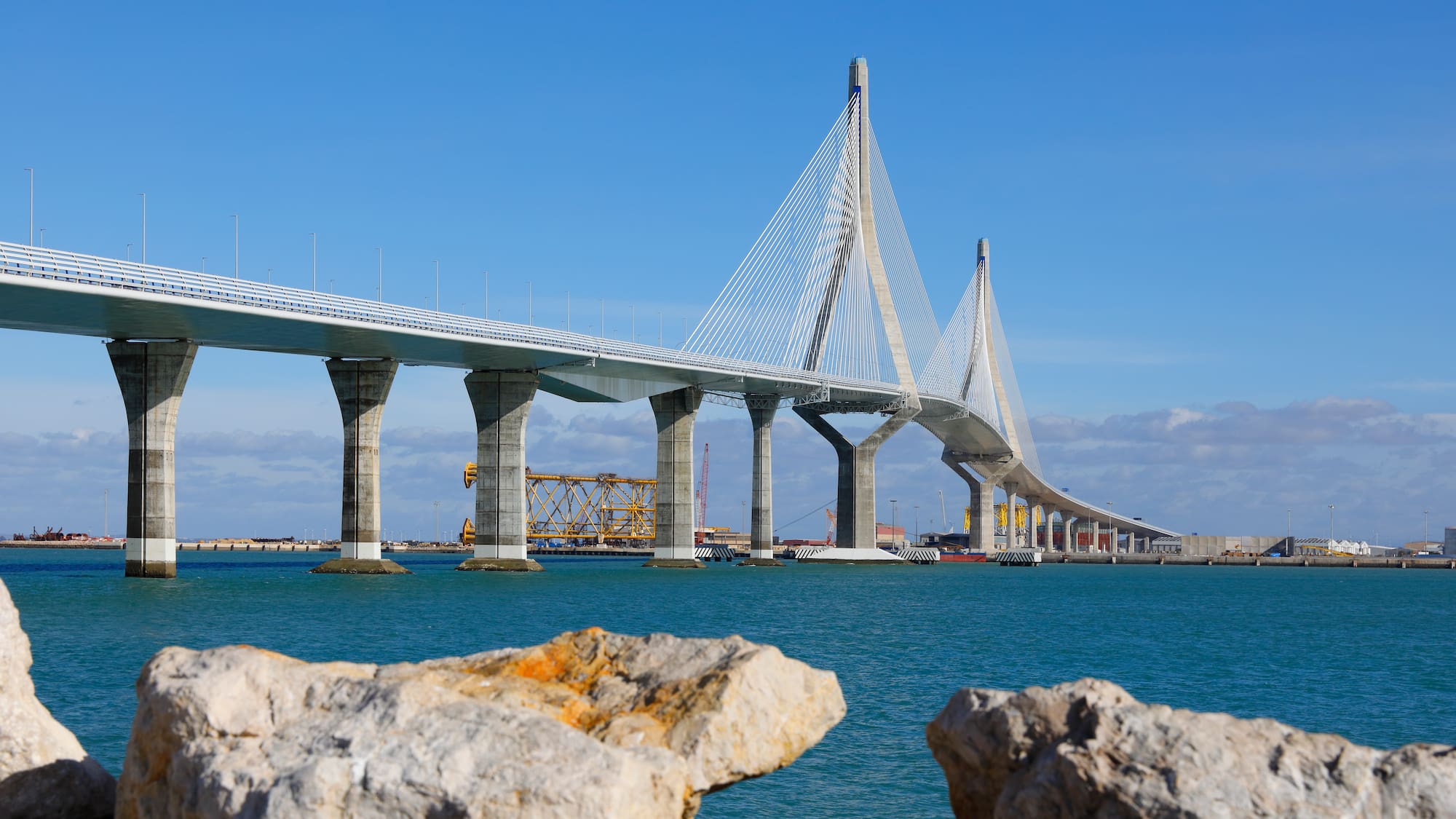 a bridge over water with rocks