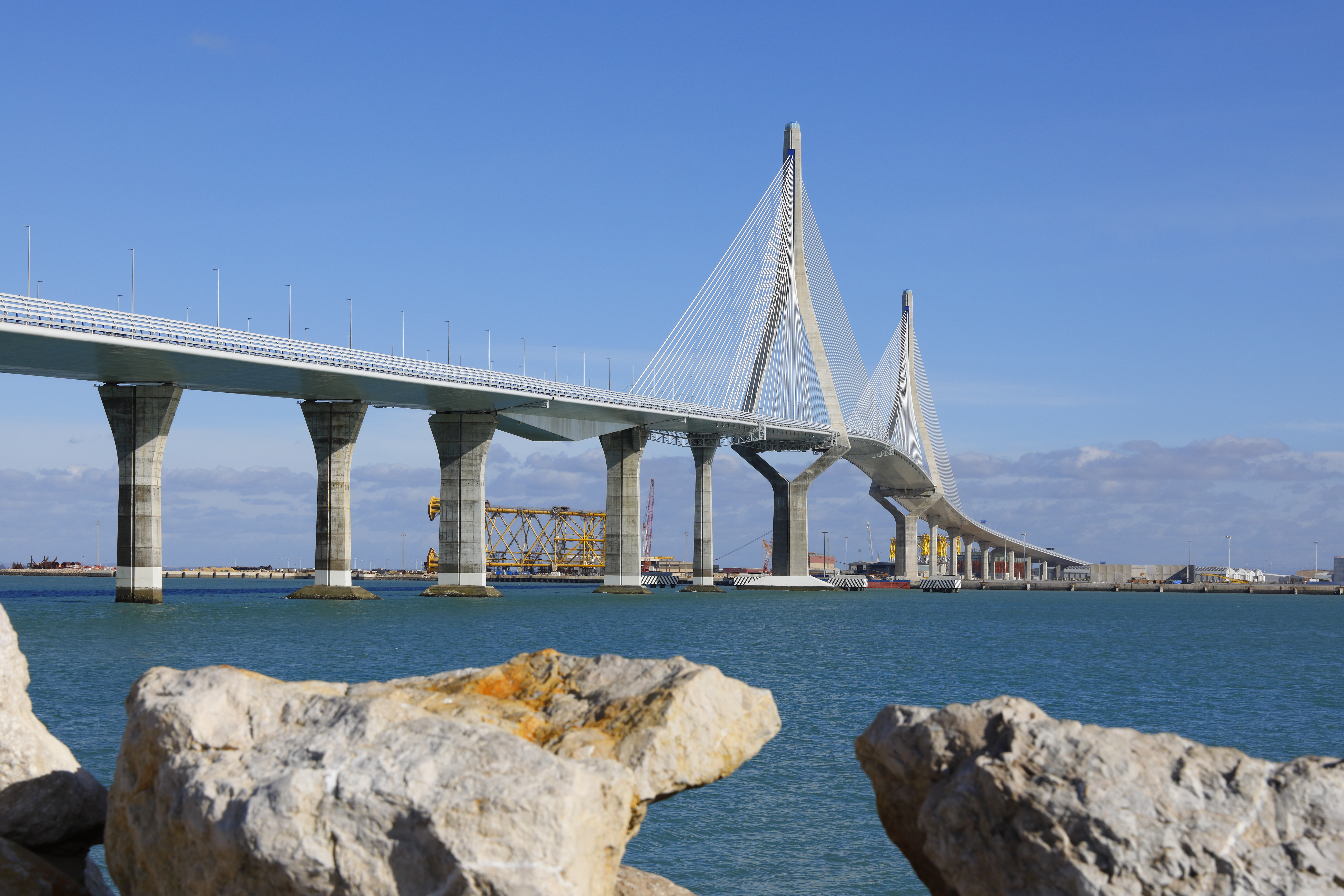 a bridge over water with rocks