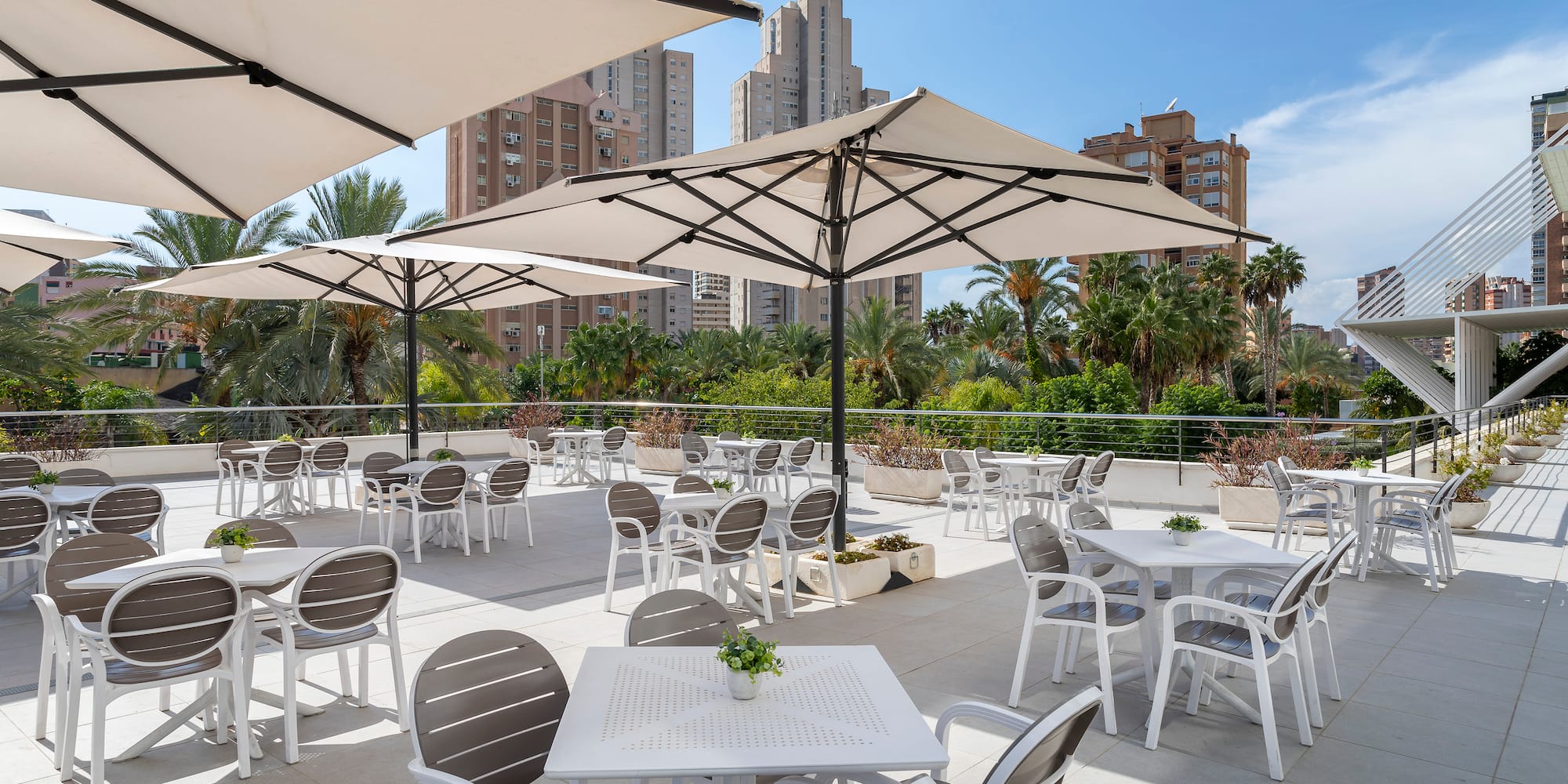 a patio with tables and umbrellas