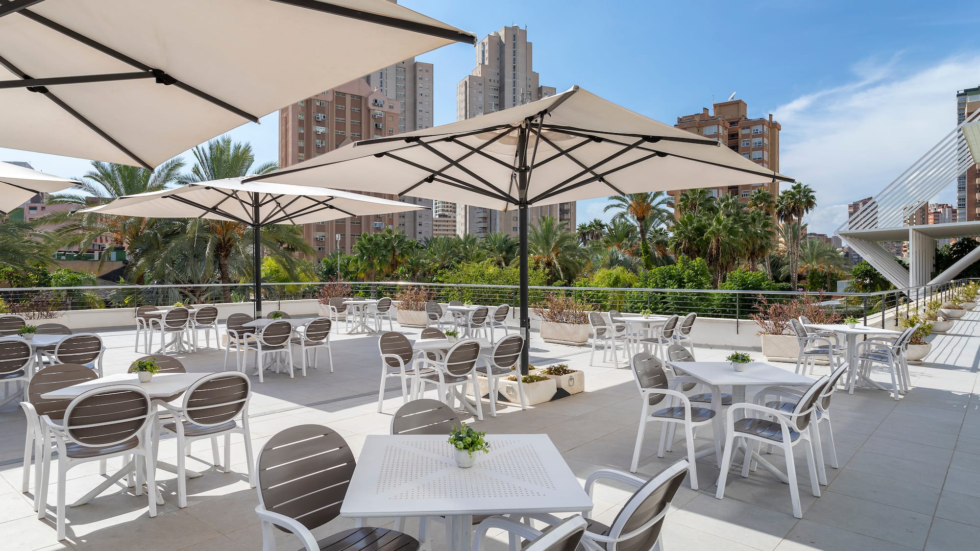 a patio with tables and umbrellas