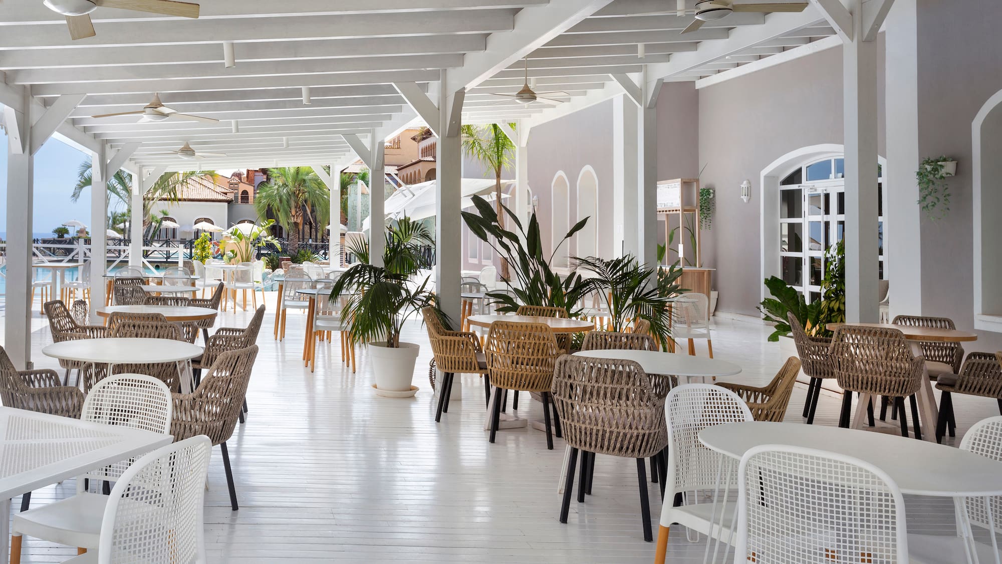 a white patio with tables and chairs
