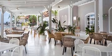 a white patio with tables and chairs