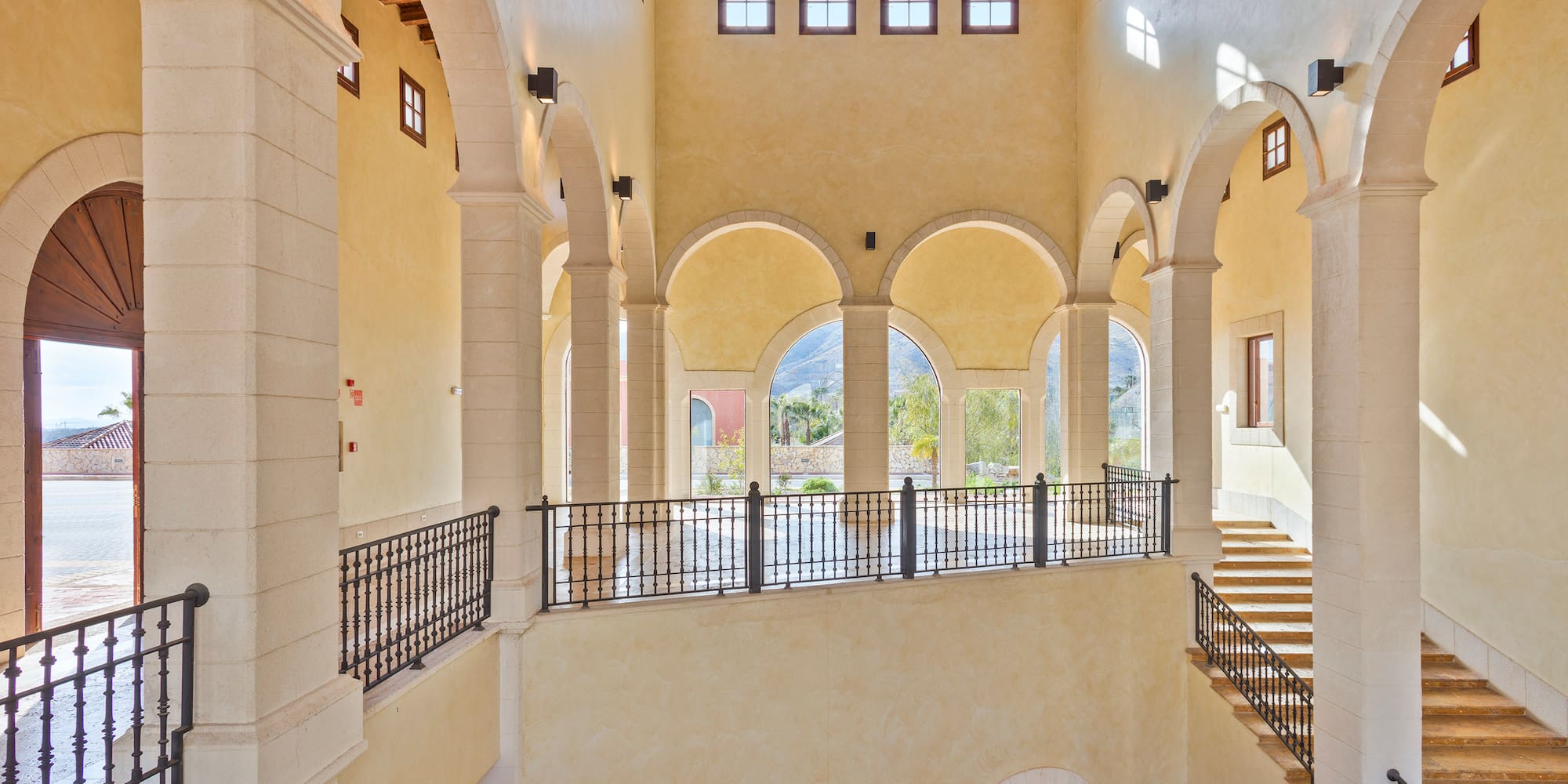 a large building with arched windows and a staircase