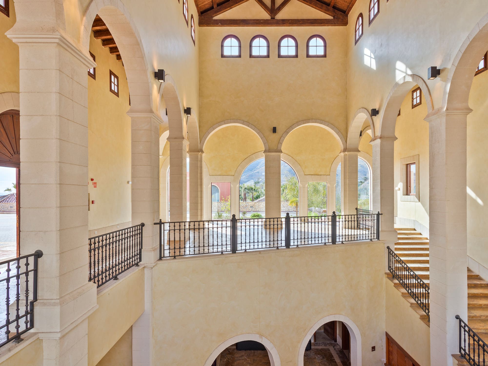a large building with arched windows and a staircase