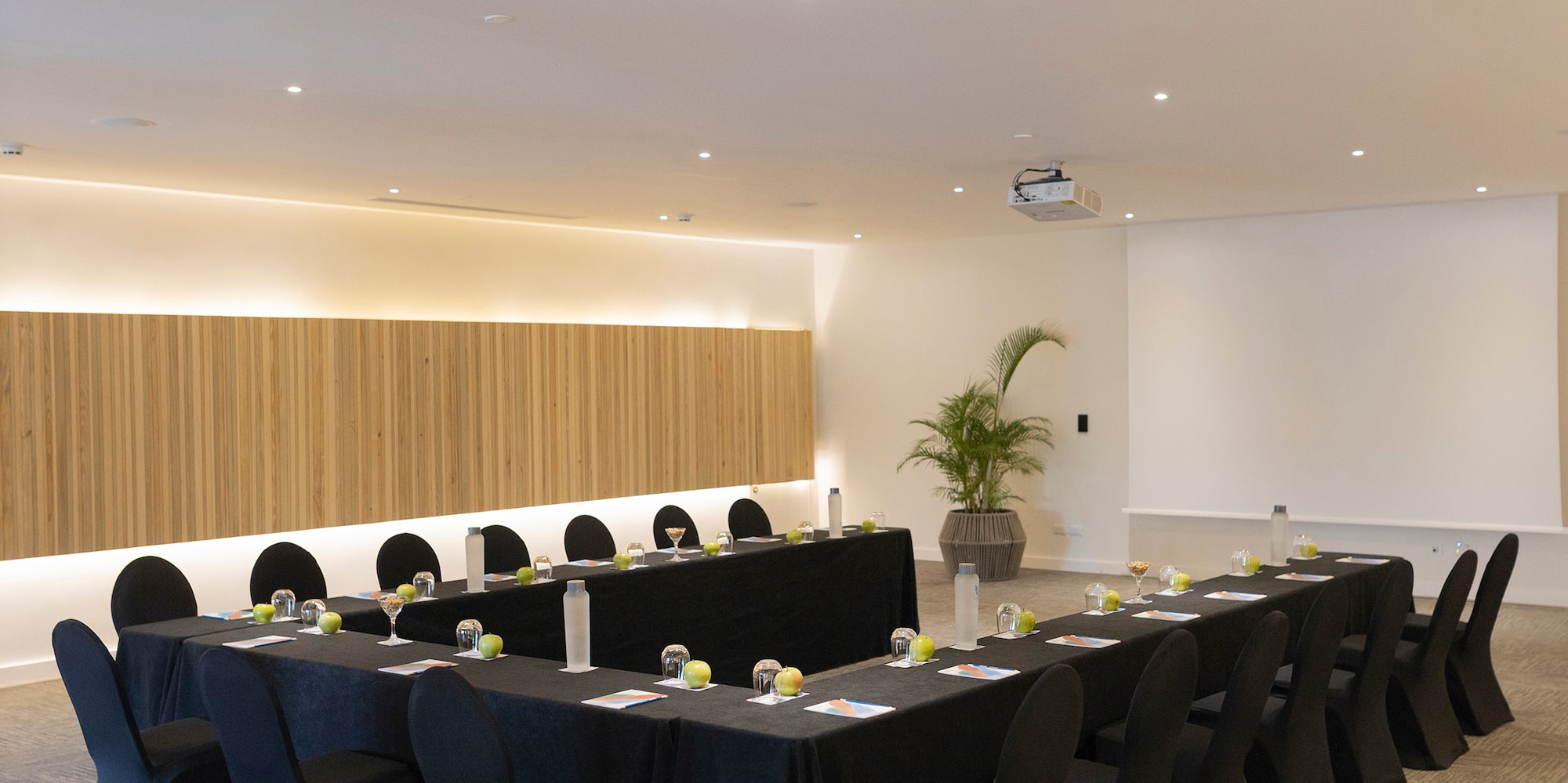 a room with long black tablecloths and chairs