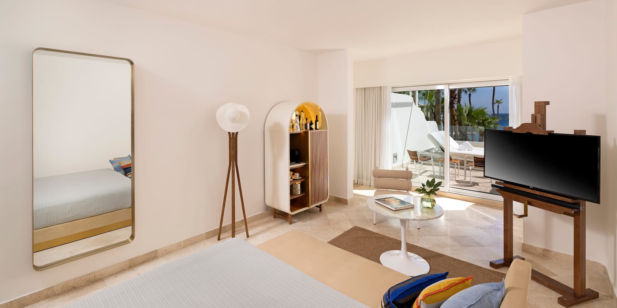 a room with a bed and a table and chairs