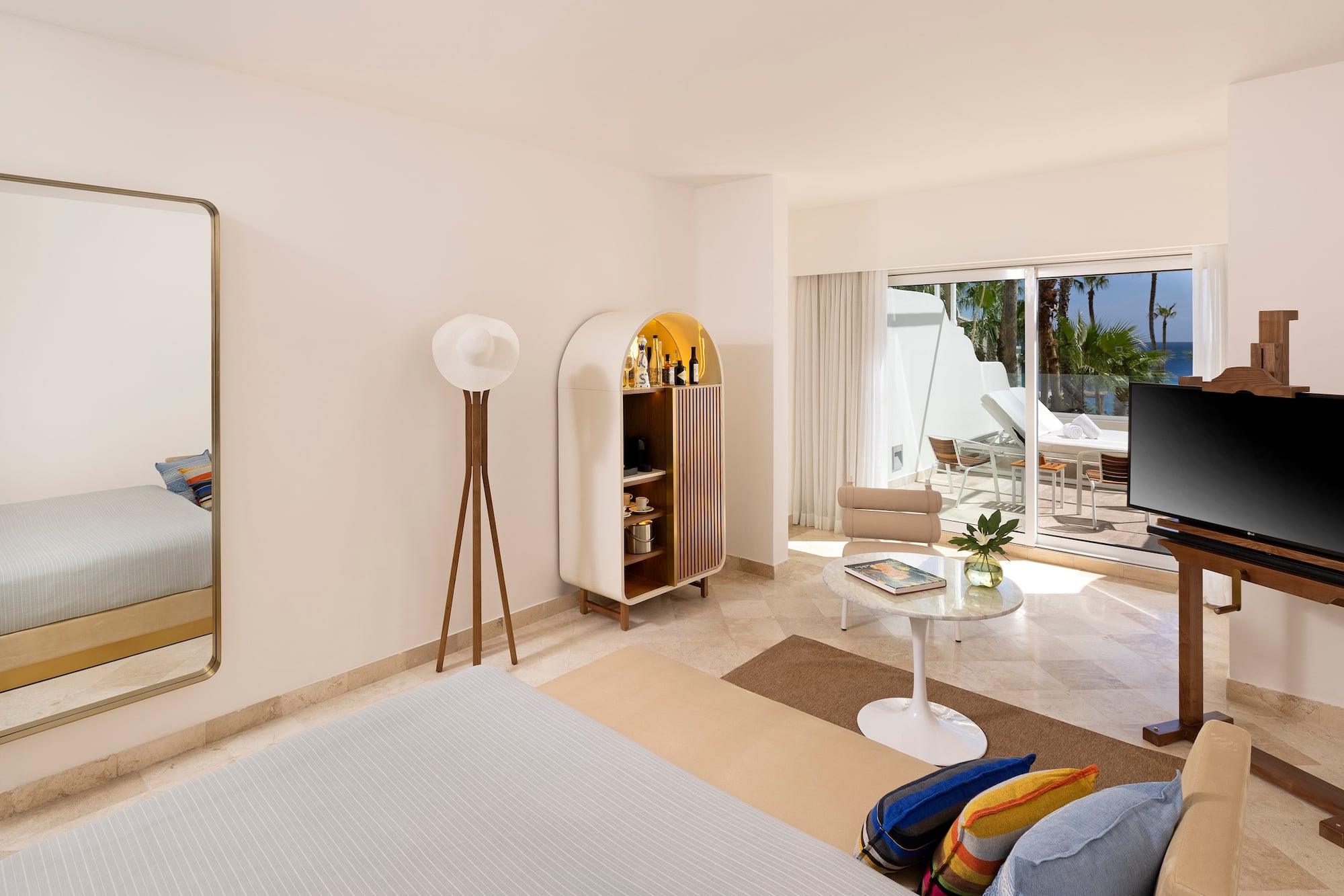 a room with a bed and a table and chairs