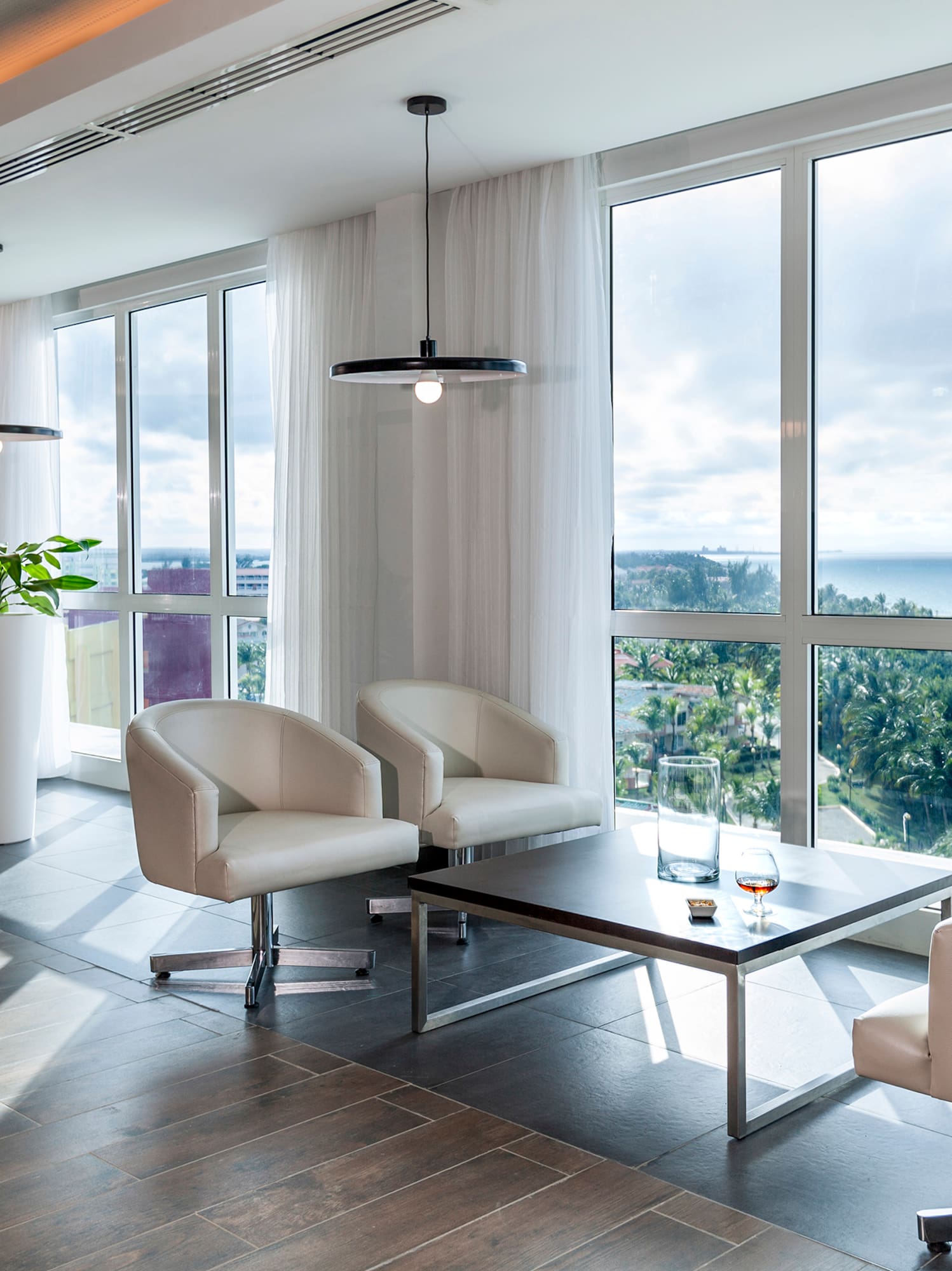 a room with white chairs and a table