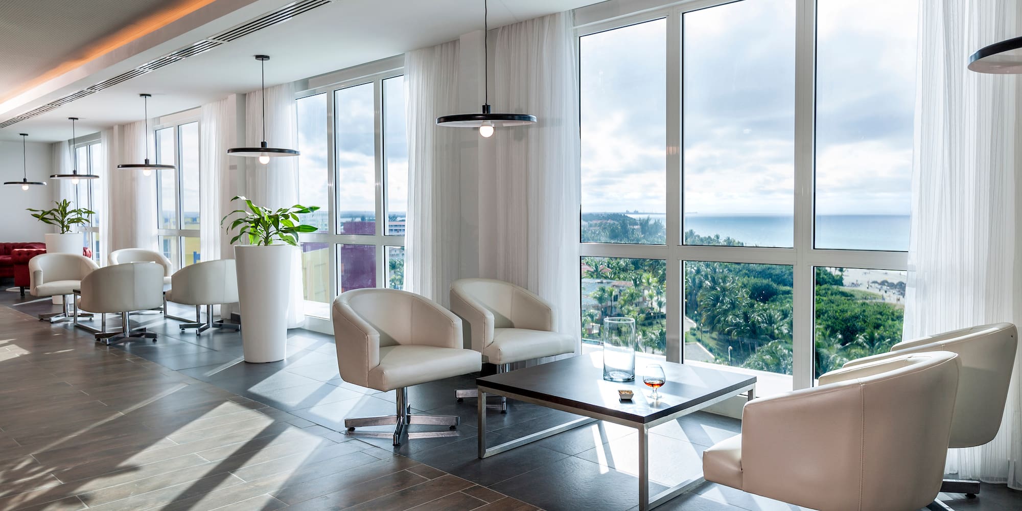 a room with white chairs and a table