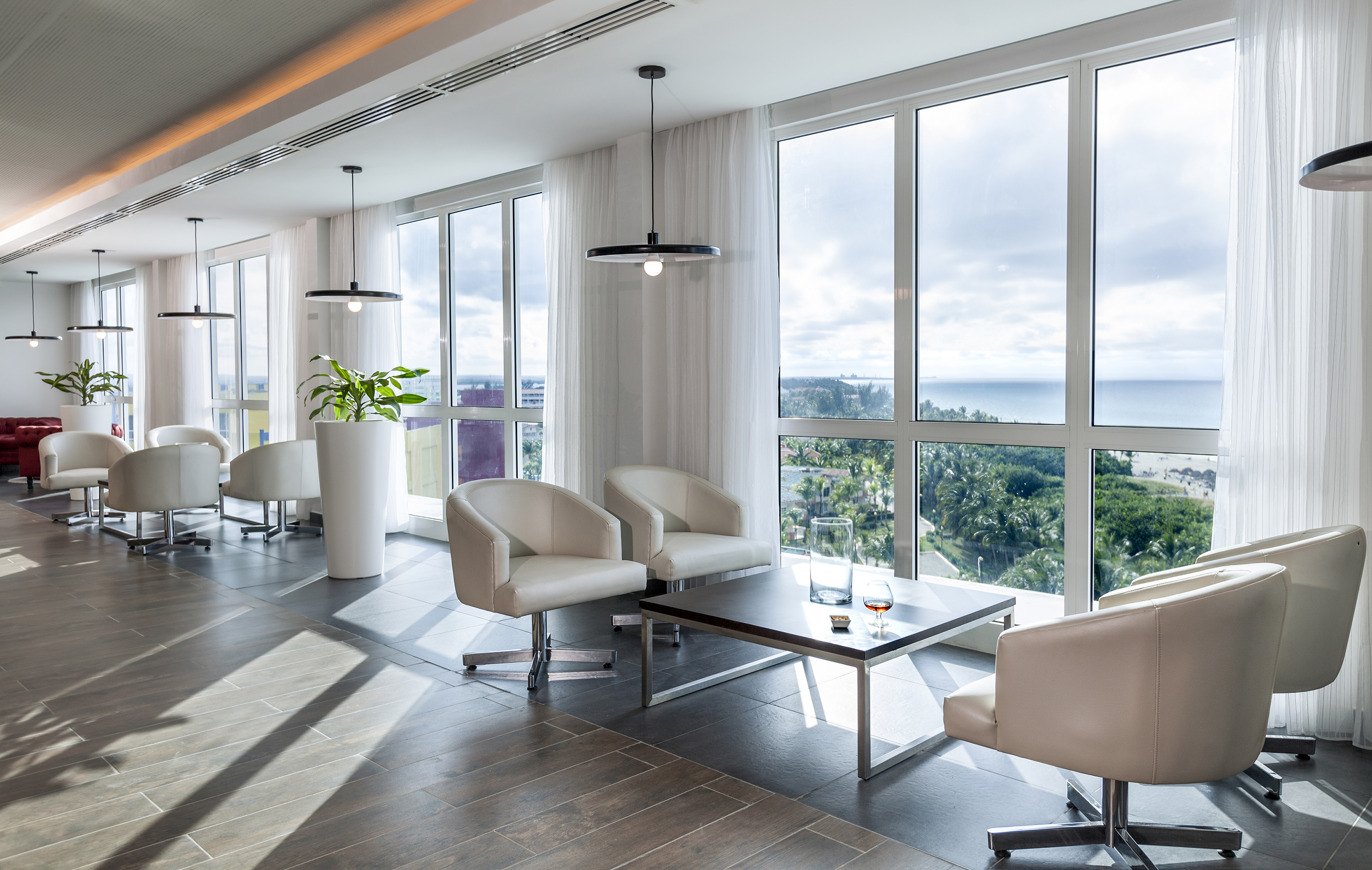 a room with white chairs and a table
