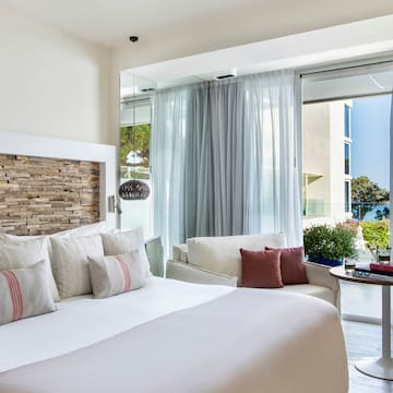a bed with pillows in a room with a glass door