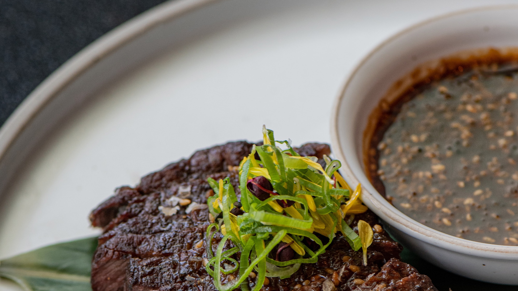 a plate of food with a bowl of sauce