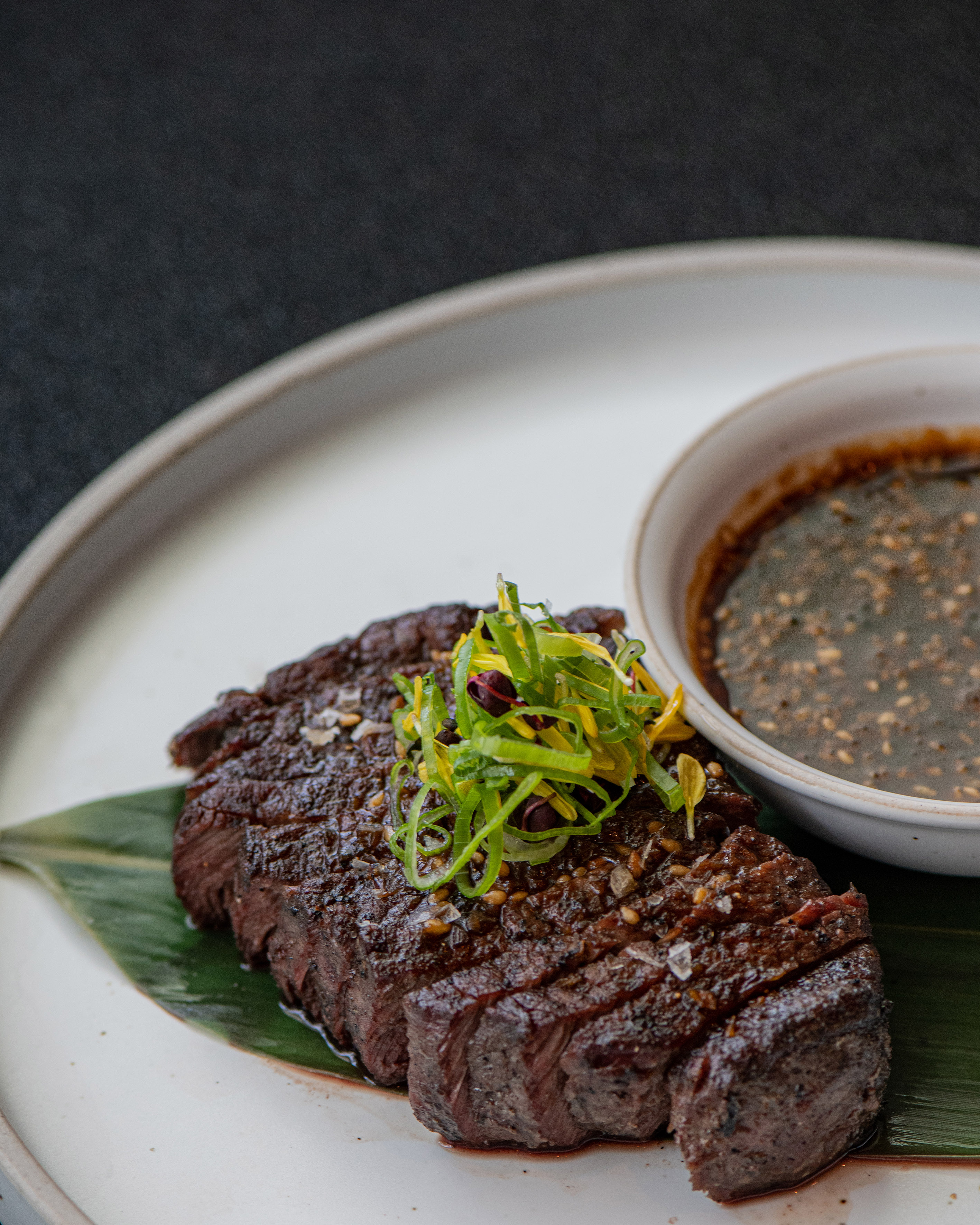 Grilled steak slices with scallions and sesame dipping sauce.