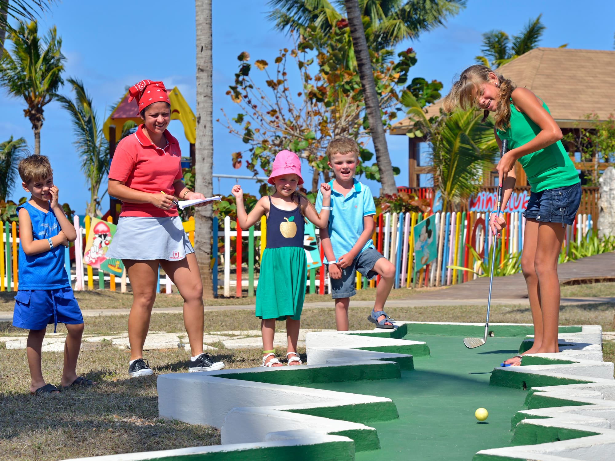 a group of people playing mini golf