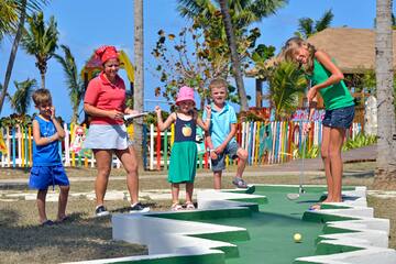 a group of people playing mini golf