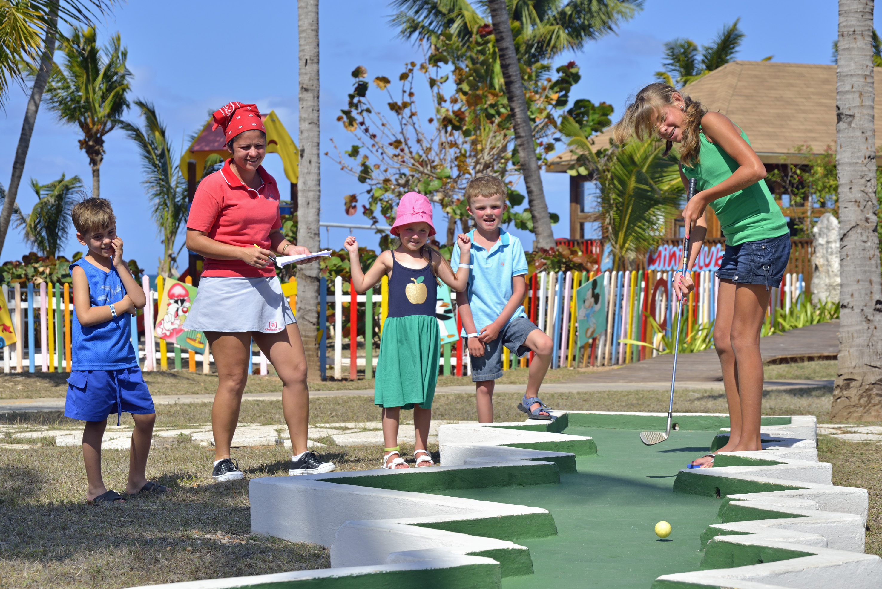 a group of people playing mini golf