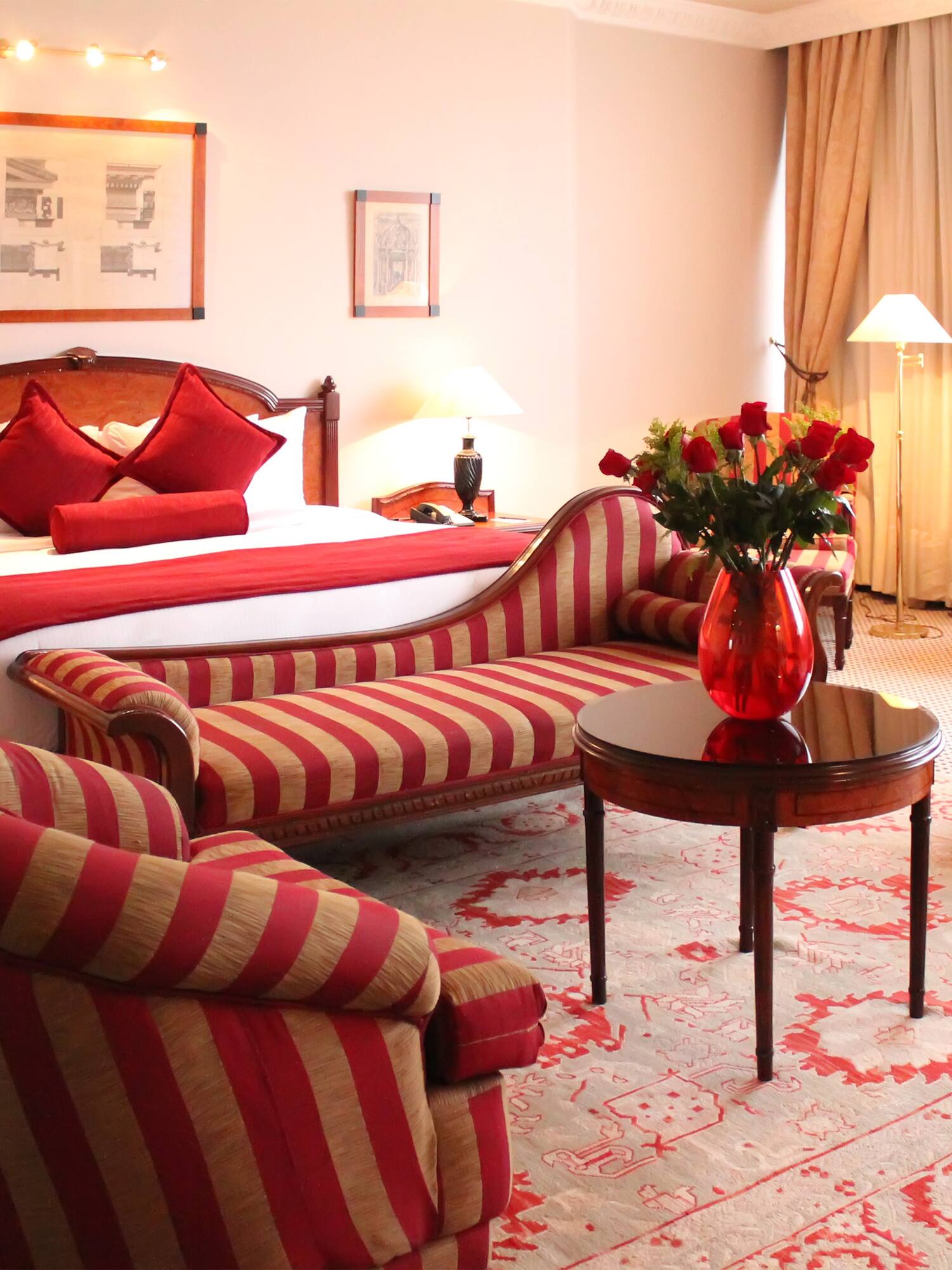 a room with a bed and chairs