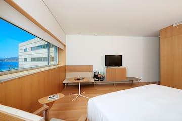 a room with a bed and a tv