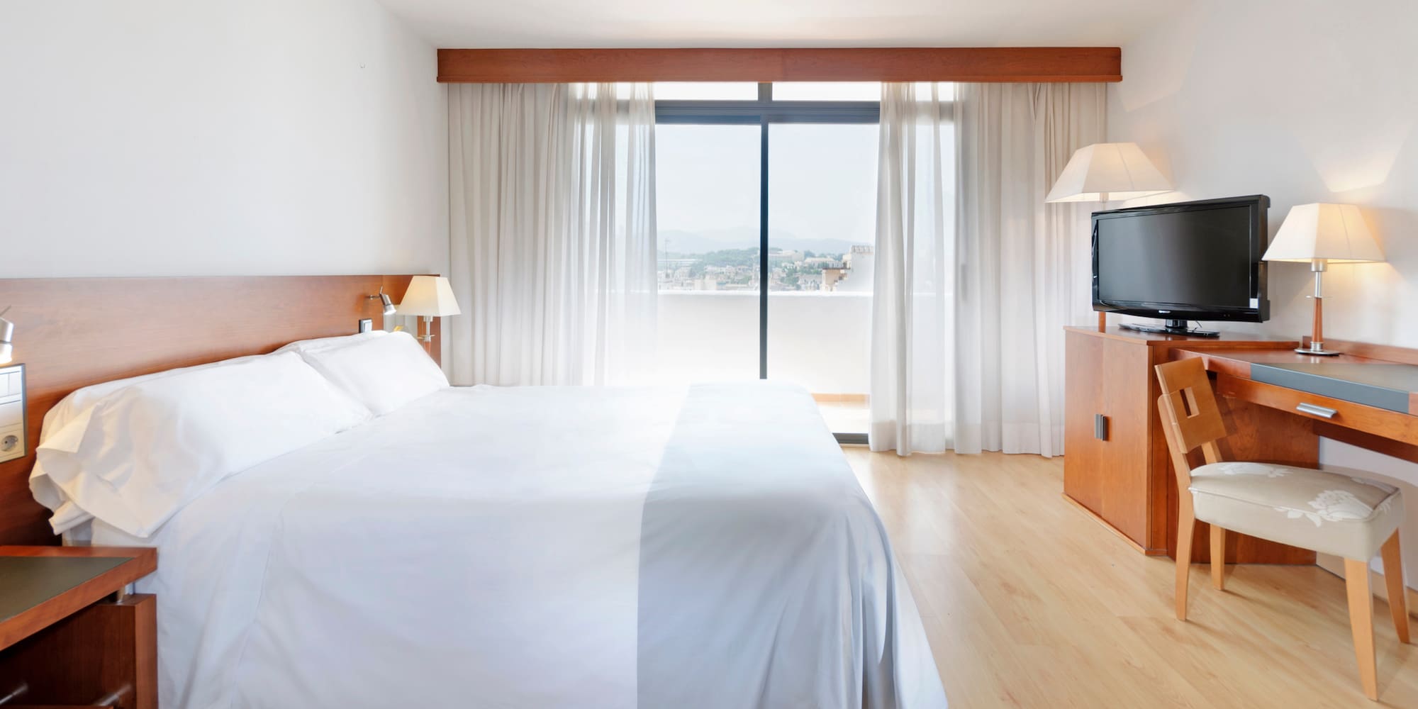 a bedroom with a large bed and a television