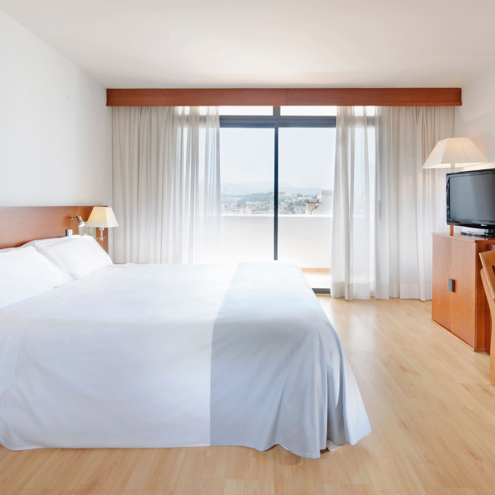 a bedroom with a large bed and a television