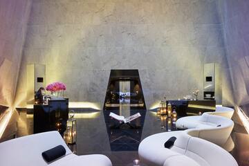 a room with a white couch and black floor