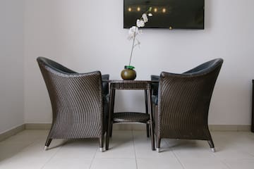 a table with chairs and a vase of flowers