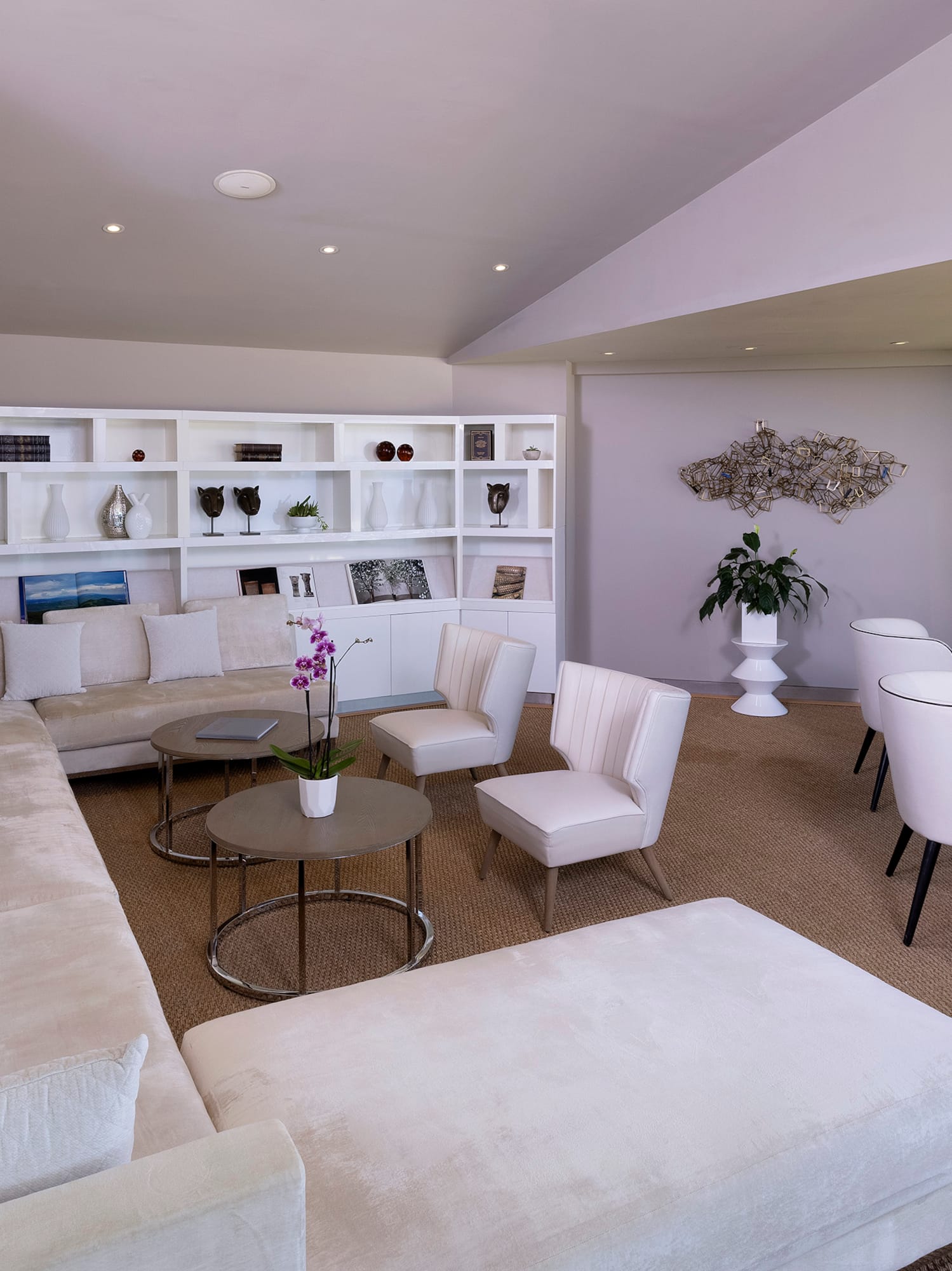 a room with white furniture and a table