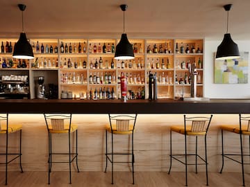 a bar with bottles of alcohol on the shelves