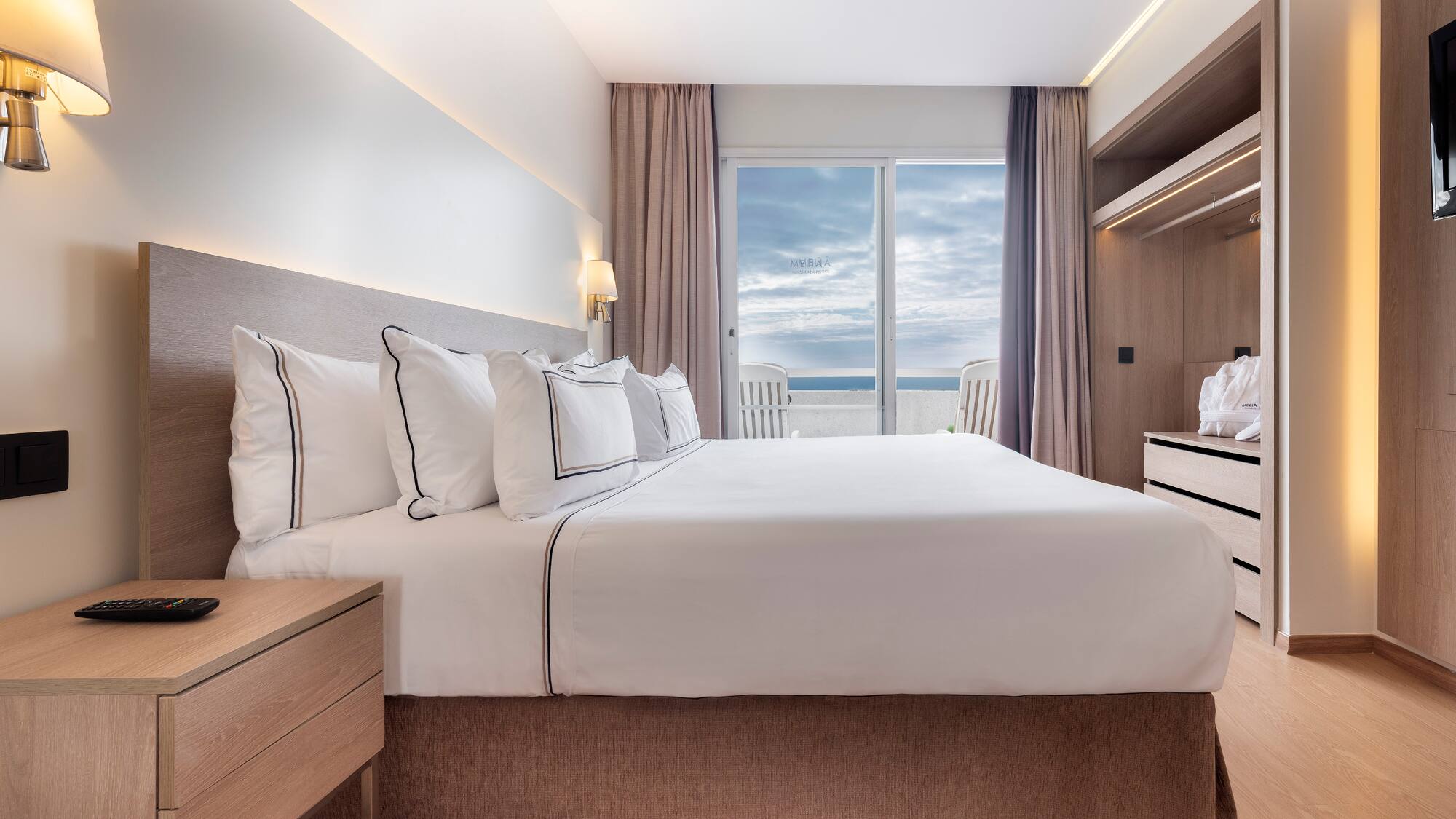 a bedroom with a large bed and a dresser