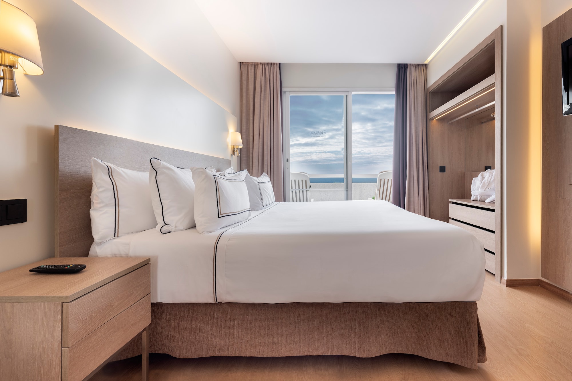 a bedroom with a large bed and a dresser